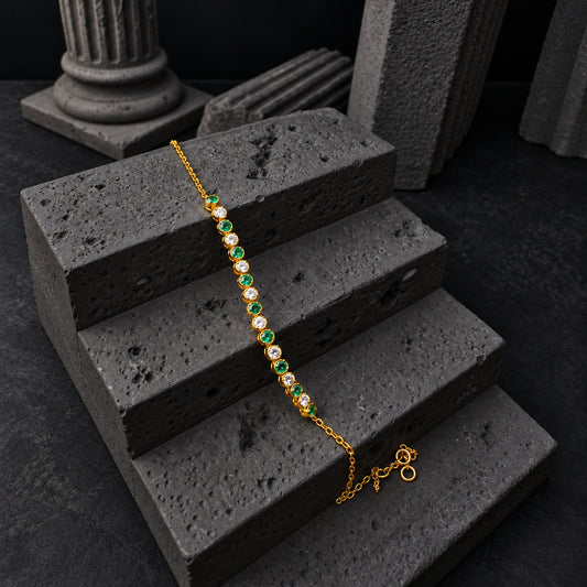 YYBR007 yellow gold alternating green and clear bracelet front view